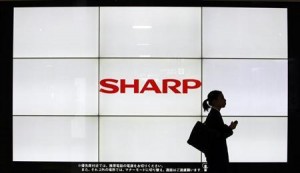 Photo of woman walking past Sharp sign