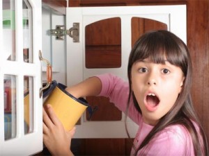 Photo of girl caught with hand in cookie jar