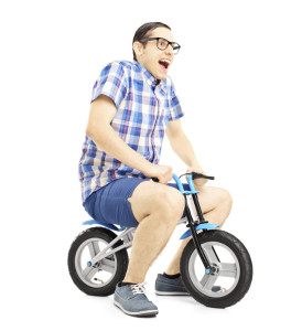 Photo of a man on a childs bike