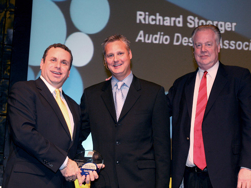 Photo of Richard Stoerger receiving a volunteer of the year award from CEDIA
