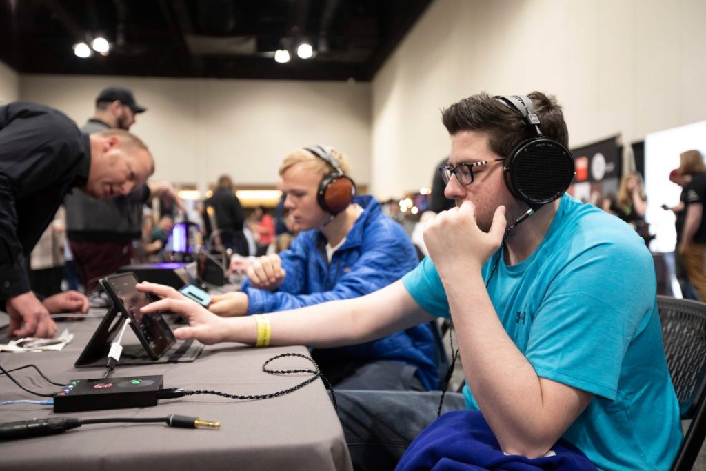 A group of attendees auditioning headphones at a previous event