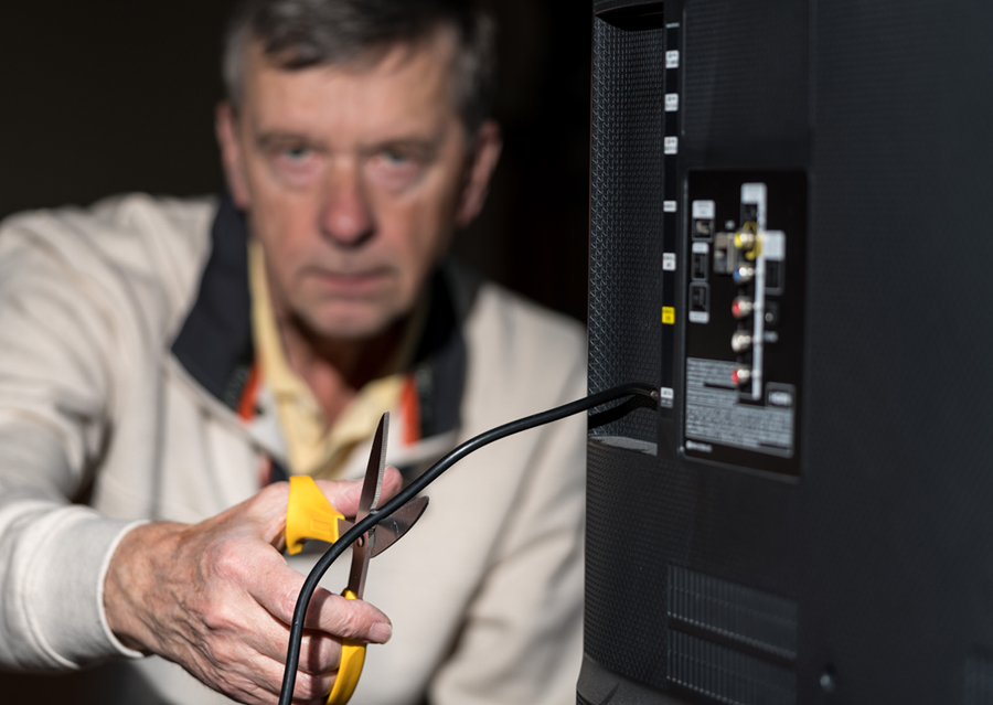 Photo of man cutting cord