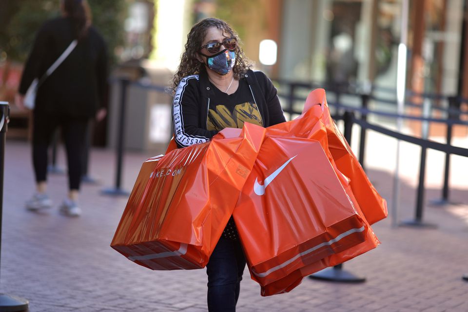 Shopper with Nike bags as inflation is one of the factors to consider
